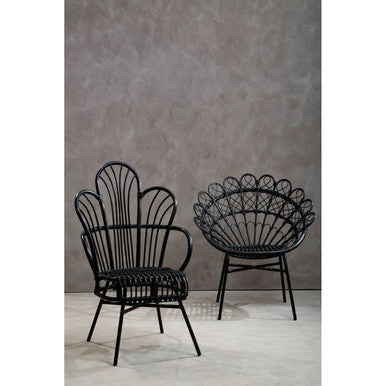 Two black wicker chairs against a gray wall.