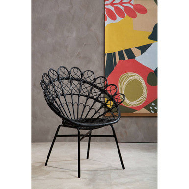 Black metal chair in a room with a colorful abstract painting on the wall.