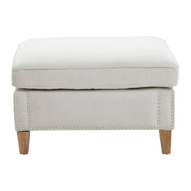 Beige ottoman with nailhead trim on a white background