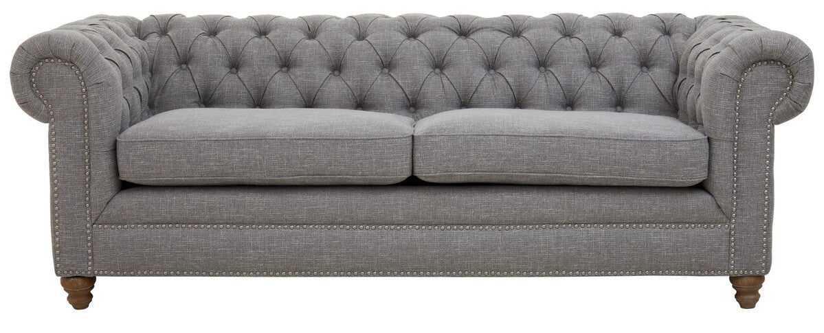 Gray tufted sofa on a white background