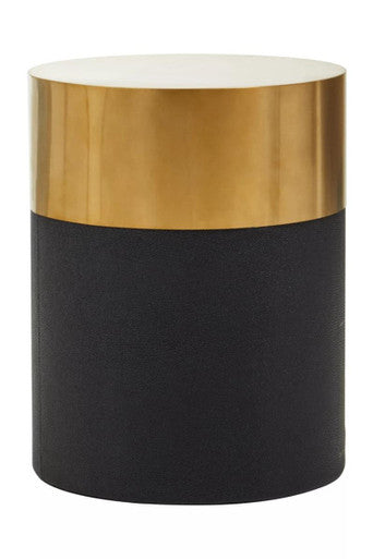 Cylindrical side table with gold top and black base on a white background