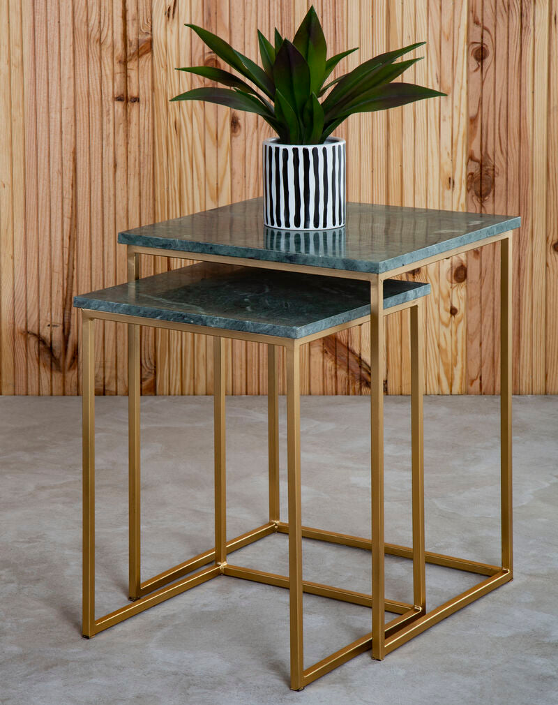 Set of two nesting tables with gold frames and green marble tops, one with a plant in a pot.