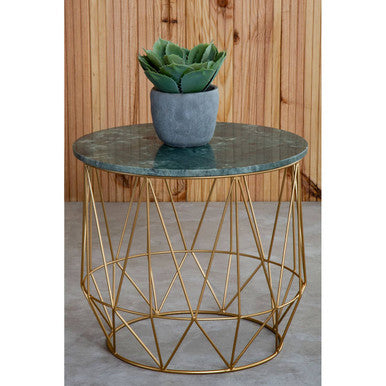 Round side table with gold geometric base and green marble top, featuring a potted plant.