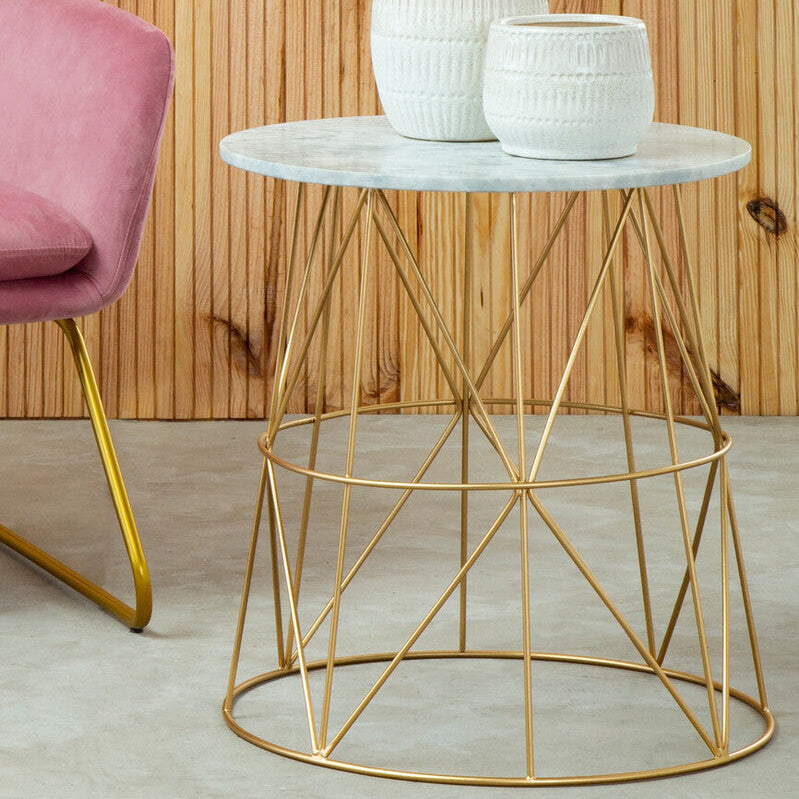 Small round marble table with gold metal base, featuring two decorative vases against a wooden panel background.