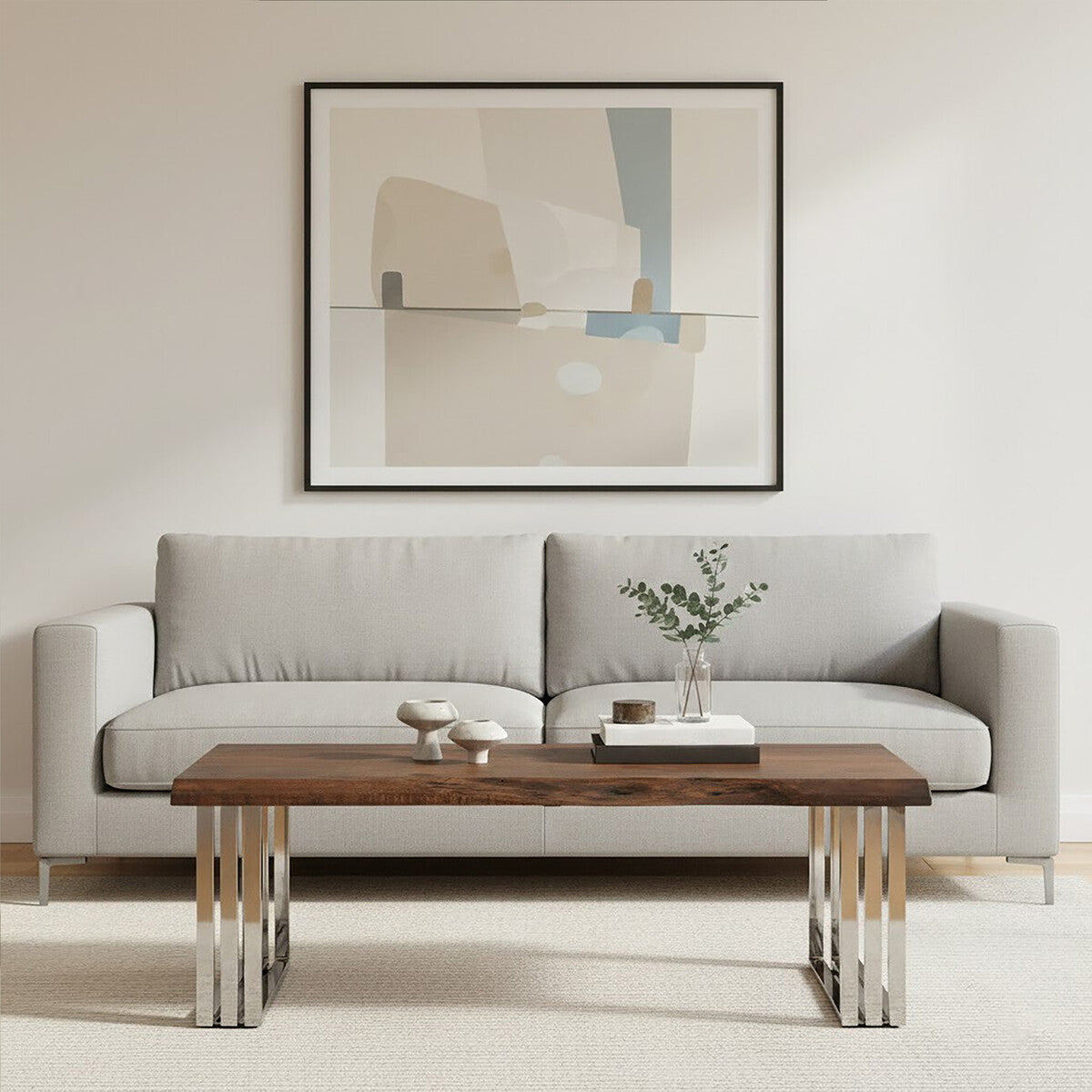 Modern living room with a gray sofa, wooden coffee table, and abstract art on the wall.