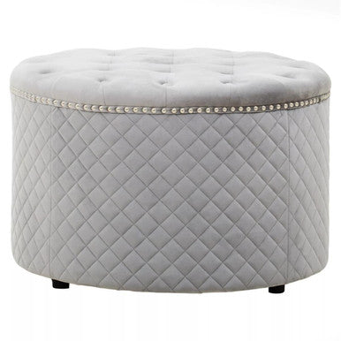 Round quilted ottoman with tufted top on a white background
