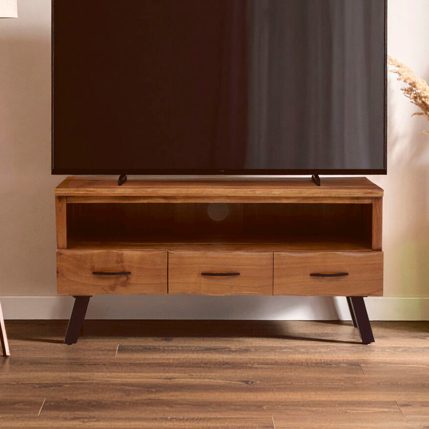 Wooden TV stand with a television on it in a room setting.