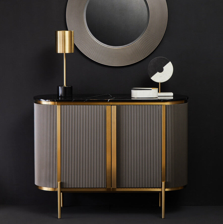 Modern sideboard with round mirror and decorative items against a black background