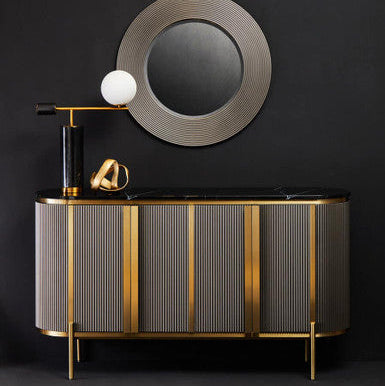 Modern bathroom vanity with round mirror and decorative elements against a black wall.