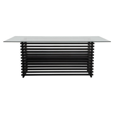 Modern dining table with black metal frame and glass top on a white background