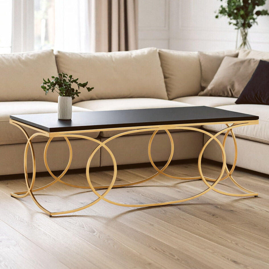 Beige sectional sofa with a gold coffee table in a modern living room.