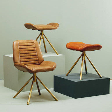 Three brown leather stools with gold metal legs on a light gray background