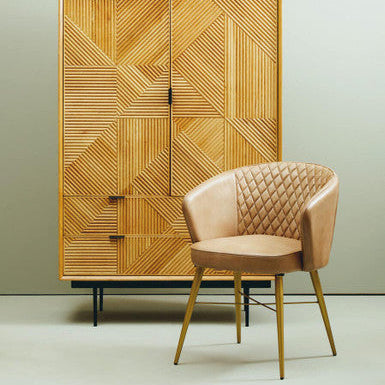 Wooden cabinet with geometric pattern and beige armchair on a light green background