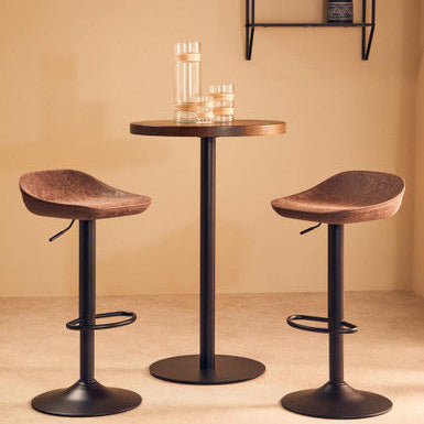 Bar height table with two stools against a beige wall.