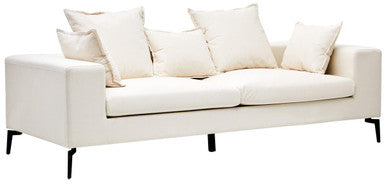 White sofa with multiple cushions on a white background