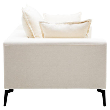 Beige upholstered bench with two pillows on a white background