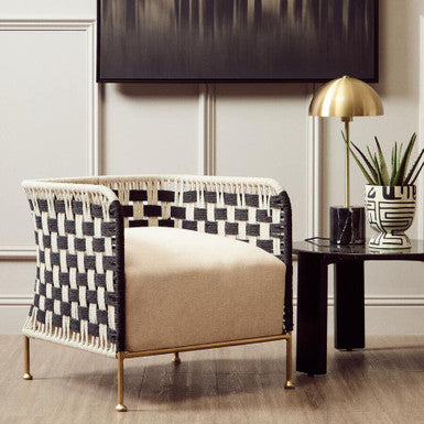 Decorative armchair with checkered backrest in a stylish room with a lamp and plant.