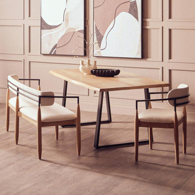 Dining room with wooden table and chairs against a wall with abstract art.