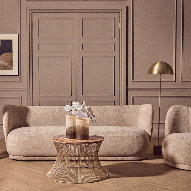 Modern living room with beige sofa, armchair, and side table.