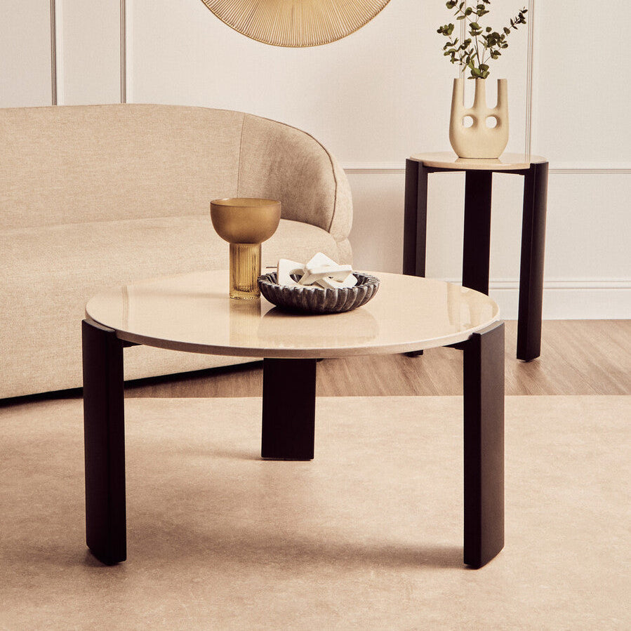 Modern living room with a coffee table, side table, and decorative items.