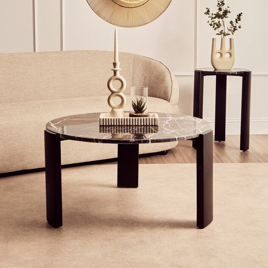 Modern living room with a marble coffee table, decorative lamp, and vase.