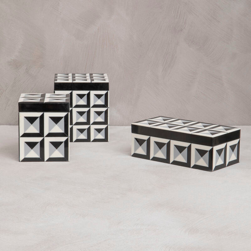 Set of three decorative boxes with black and white geometric pattern on a gray background