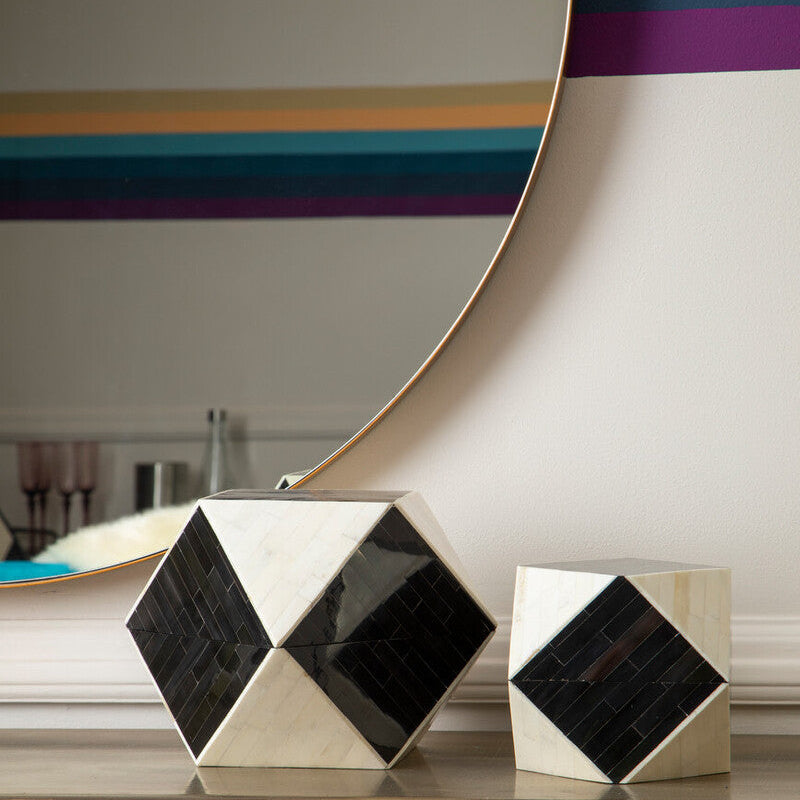 Decorative items on a wooden surface with a mirror in the background