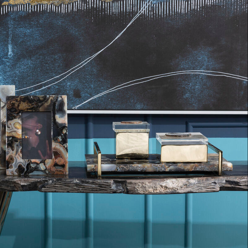 Decorative items on a table with abstract art in the background