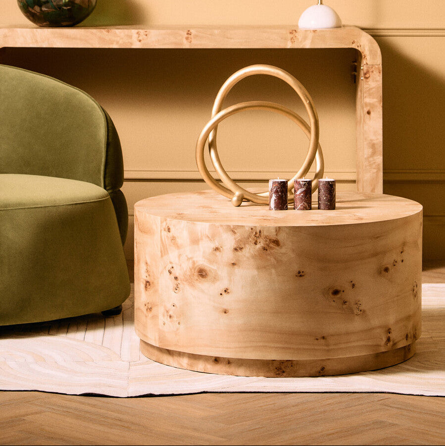 Wooden box with handles on a wooden surface next to a green chair.