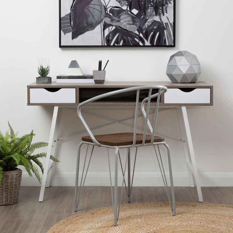 Modern home office with a desk, chair, and decorative items.