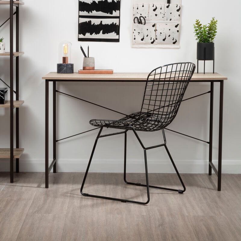Modern desk with black wire chair in a minimalistic room.