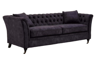 Dark gray sofa with tufted backrest on a white background