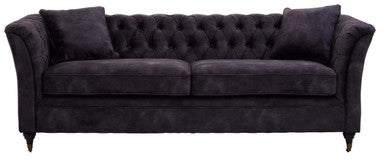 Dark gray sofa with tufted backrest on a white background