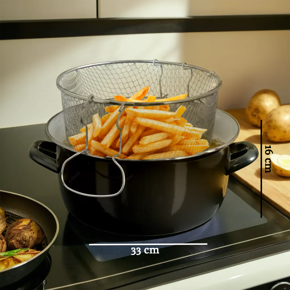 Black pot with a strainer filled with fries on a stove, with measurements indicated.