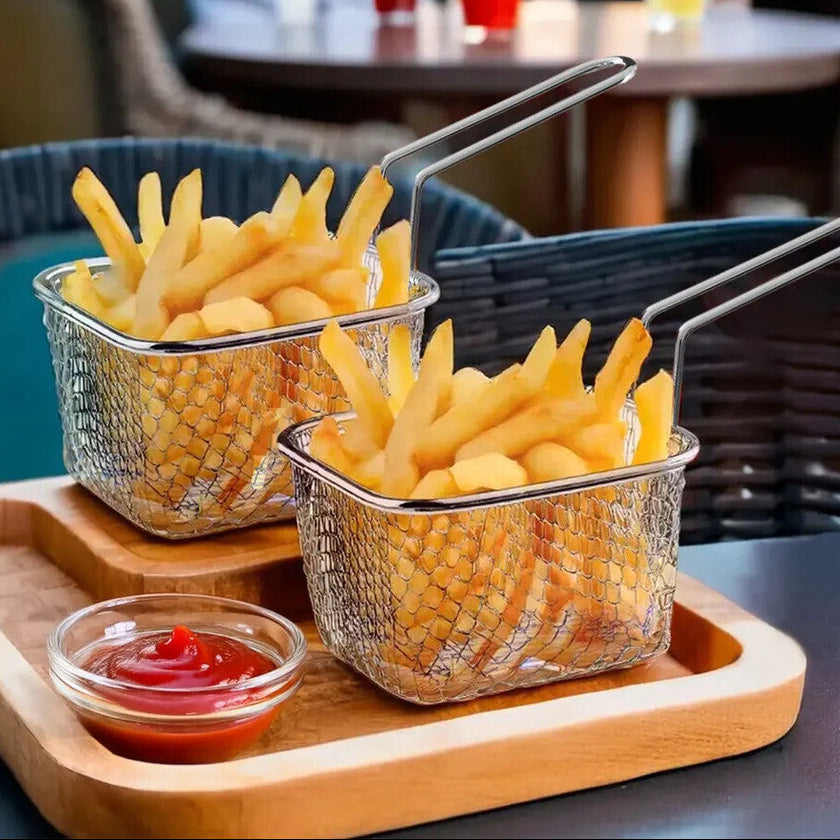 Tray with French fries, ketchup, and a drink with a red straw on a table with people in the background.