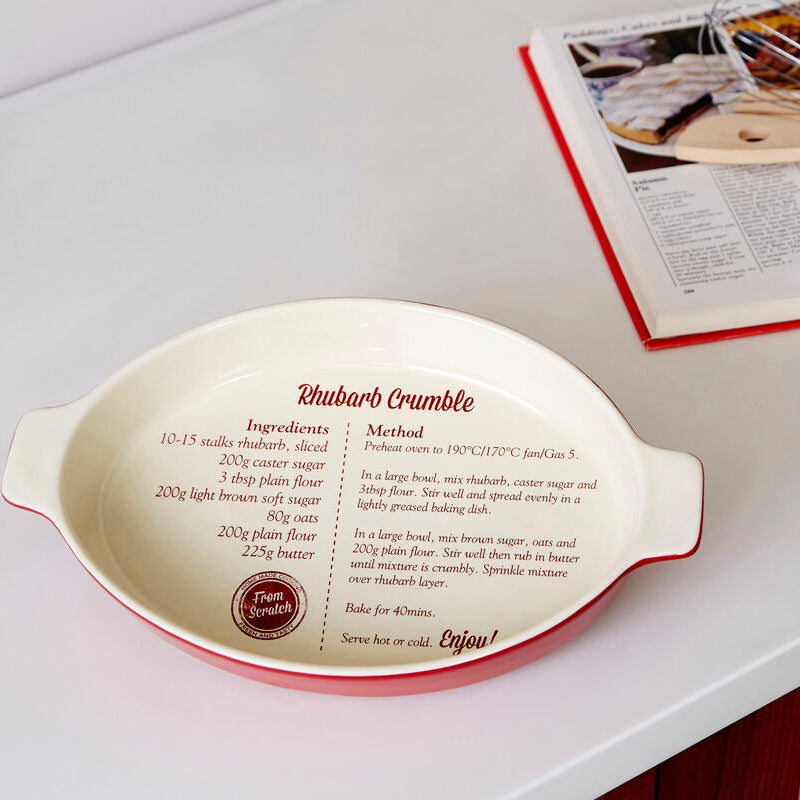 Decorative baking dish with recipe text on a kitchen counter
