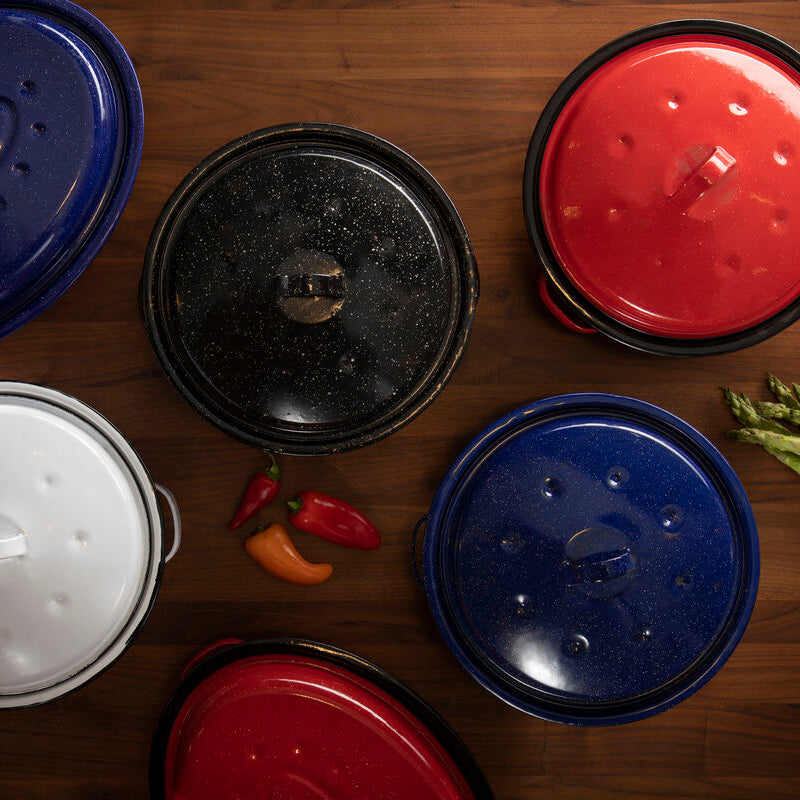 Collection of variously colored lids on a wooden surface with vegetables.
