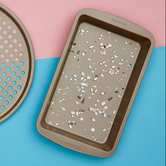Set of terrazzo-patterned trays on a colorful geometric background