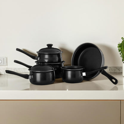 Set of black cookware including pots and a frying pan on a kitchen counter.