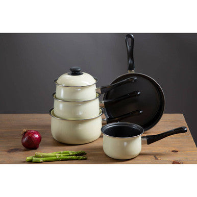 Set of white cookware with black handles on a wooden surface.