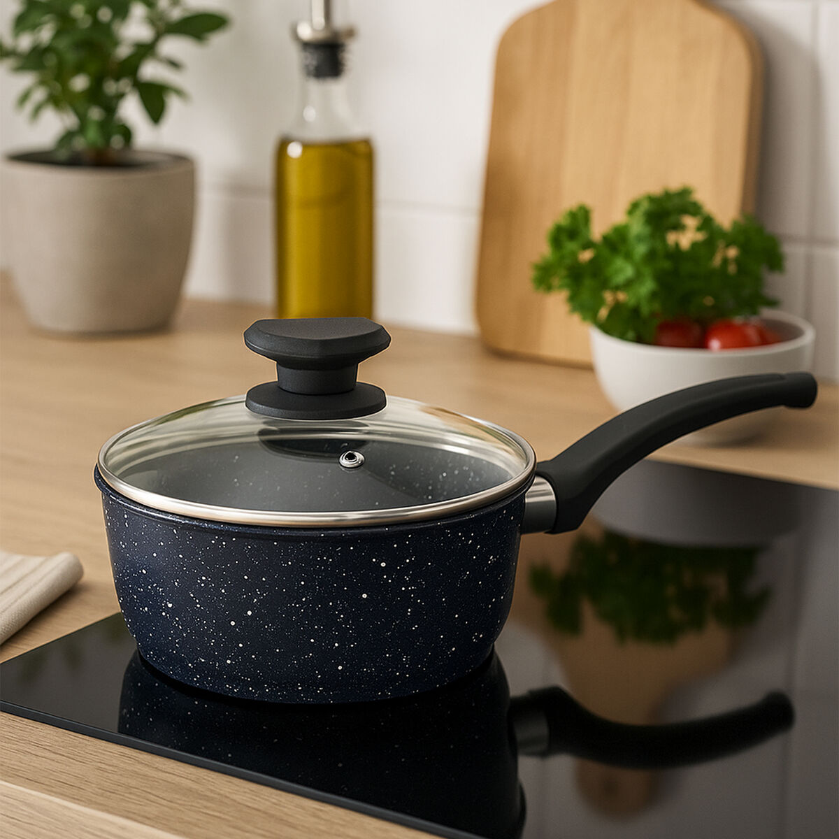 Black speckled cookware pot with lid on a kitchen counter
