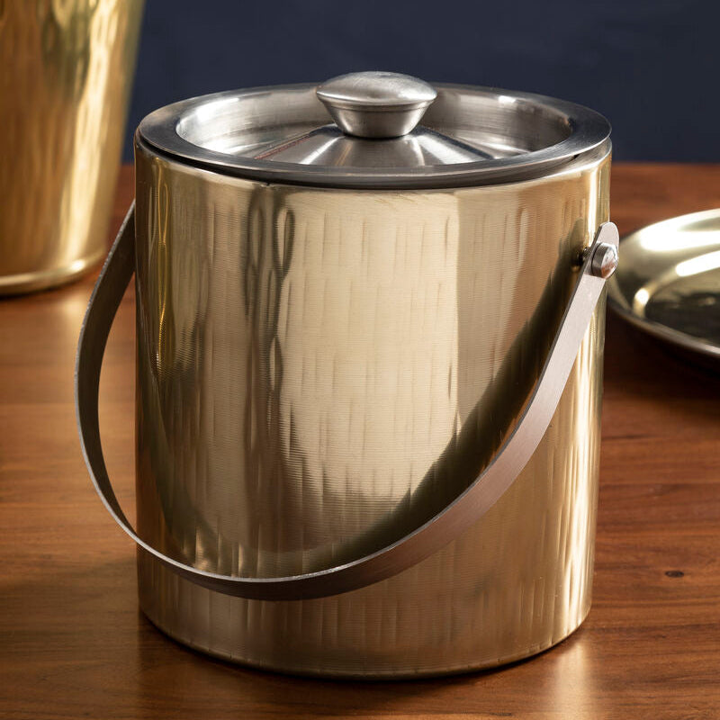 Metallic ice bucket with lid on a wooden surface