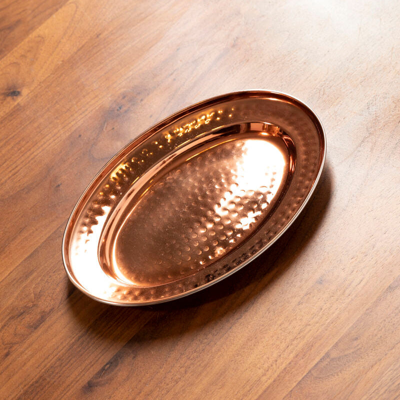 Copper tray on a wooden surface