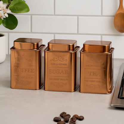 Set of three copper-colored kitchen canisters labeled &