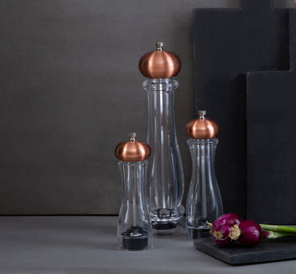 Black cutting boards with copper accents on a gray background