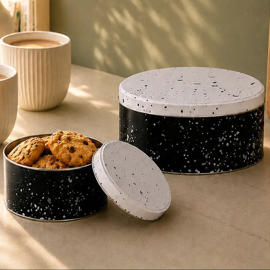 Speckled ceramic cookie jars on a table with a minimalist design label.