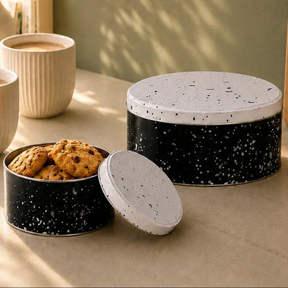 Speckled ceramic cookie jars on a table with a minimalist design label.