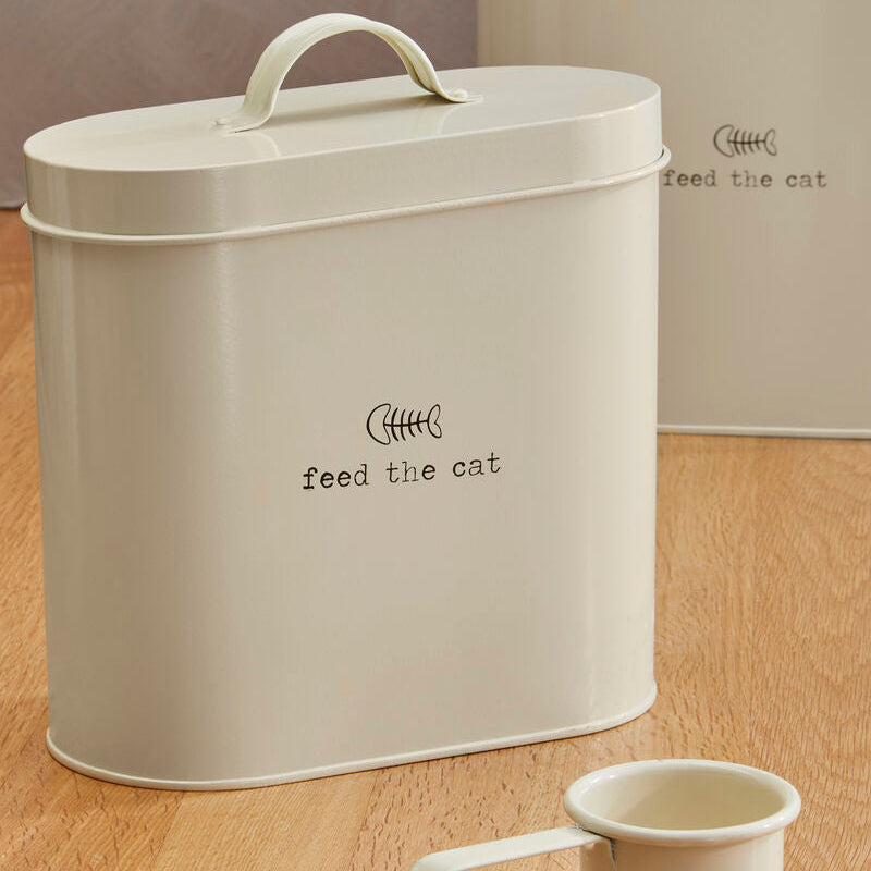 Beige cat food storage container with a small white cup on a wooden surface.