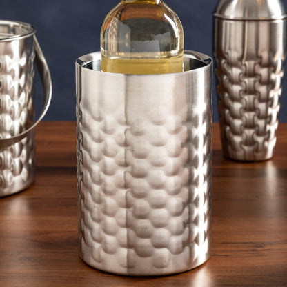 Silver textured wine cooler with a bottle of white wine on a wooden surface.
