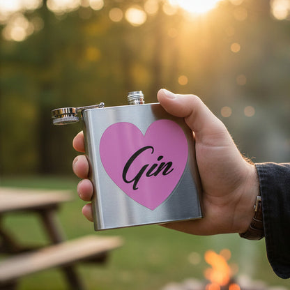 Hand holding a stainless steel flask with a pink heart and &